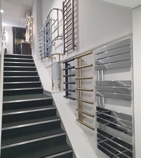 Designer heated towel rail display on the showroom stairway at Blue Sky