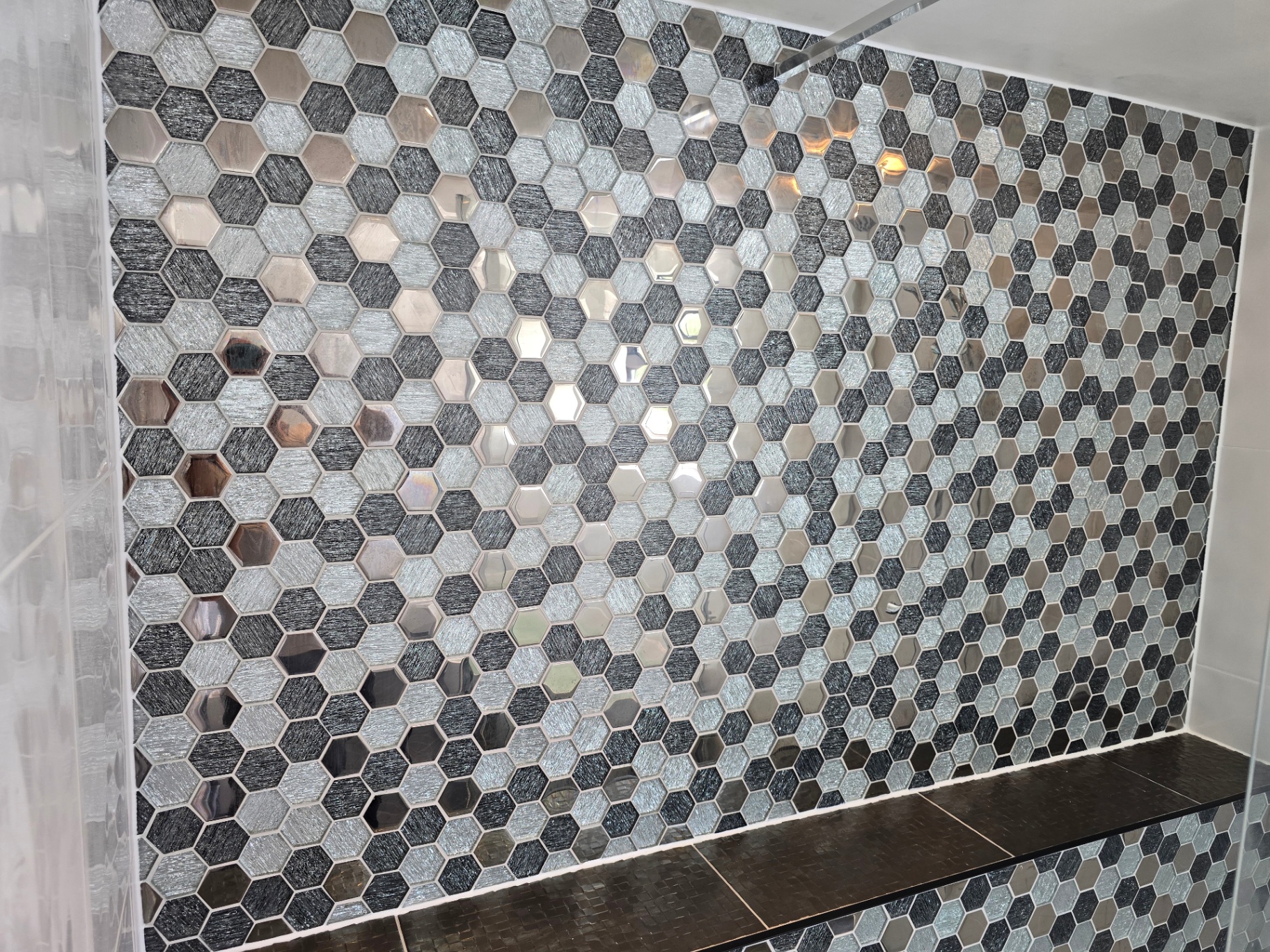 Hexagonal glass and metallic mosaic tile detail in a Tamworth bathroom