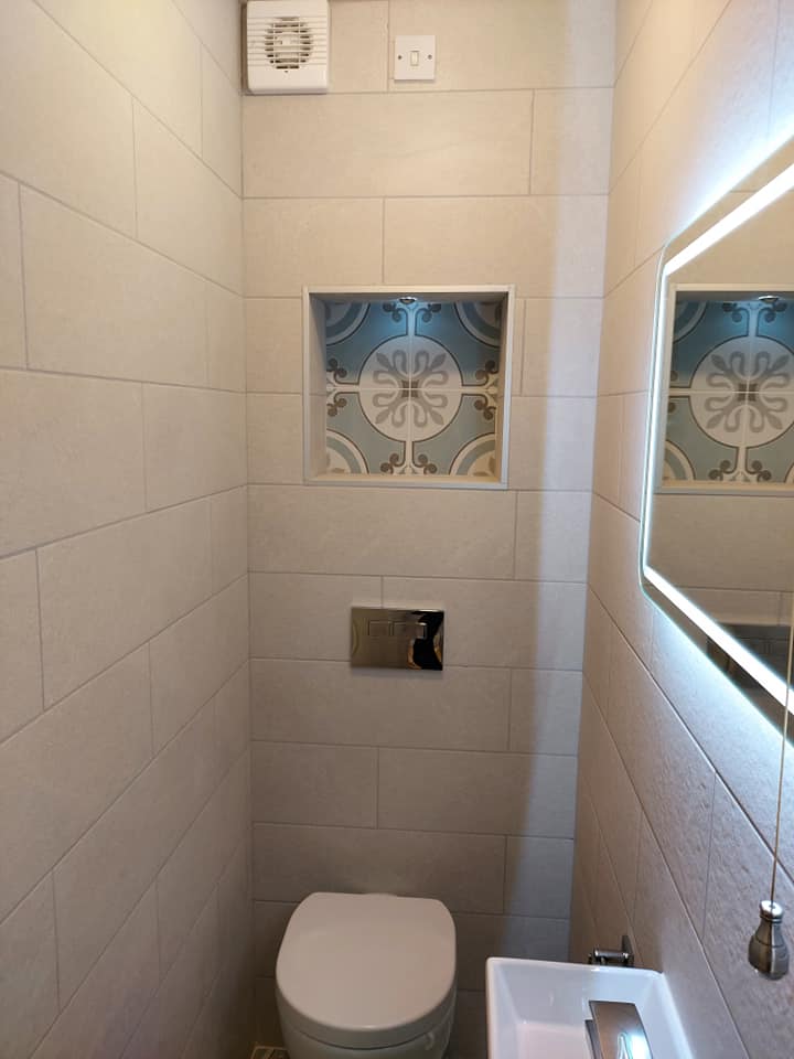 Cloakroom WC with decorative tile niche and flush plate detail in Tamworth