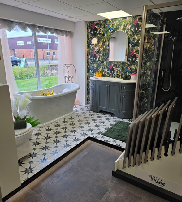 Tropical wallpaper feature wall with grey vanity, freestanding bath and walk-in shower at the Tamworth showroom
