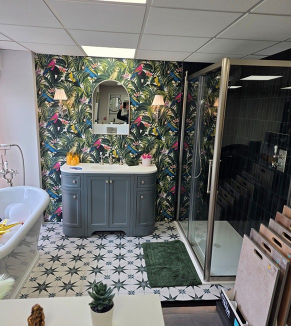 Grey curved vanity with tropical wallpaper and shower enclosure display at the Tamworth showroom