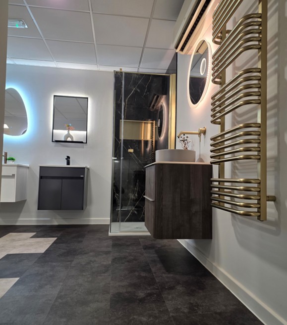 Brushed-gold heated towel rail with floating vanity and dark marble shower display at the Tamworth showroom