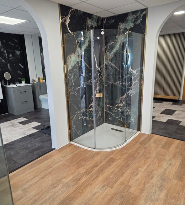 Curved gold-trim shower enclosure with onyx-effect marble panels at the Tamworth bathroom showroom