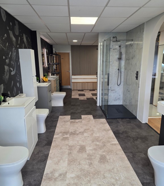 Centre runway of the Tamworth showroom with vanity, WC and walk-in shower displays under bright lighting