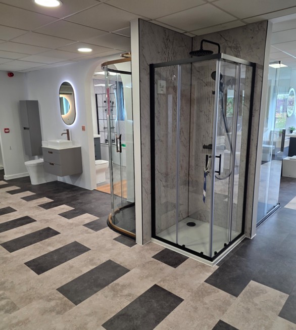 Square chrome shower enclosure with marble walls and rainfall head at the Tamworth bathroom showroom